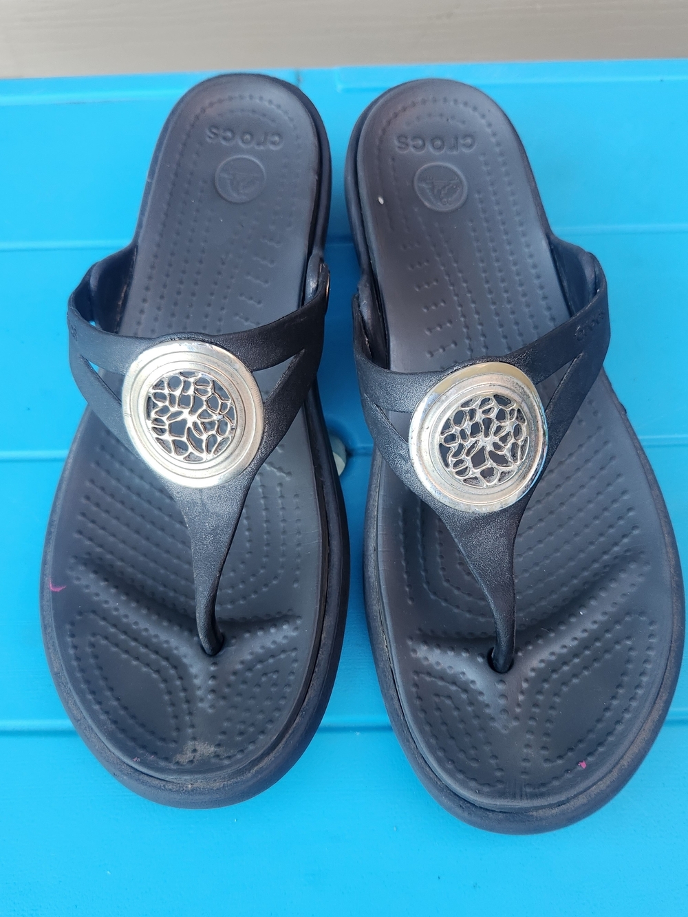 CROCS Black Thong Sandals with Silver Medallion Accent
